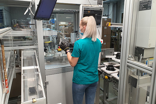 Employee checking a cable rewinder at the test station