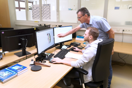 Employees developing a rewinding system on the computer