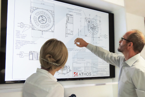 Two people looking at technical drawing