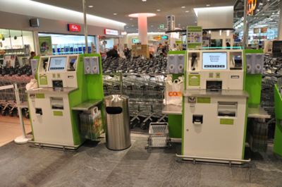 View of self-service checkouts in supermarkets
