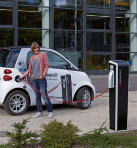 Woman charging her electric car at the charging station